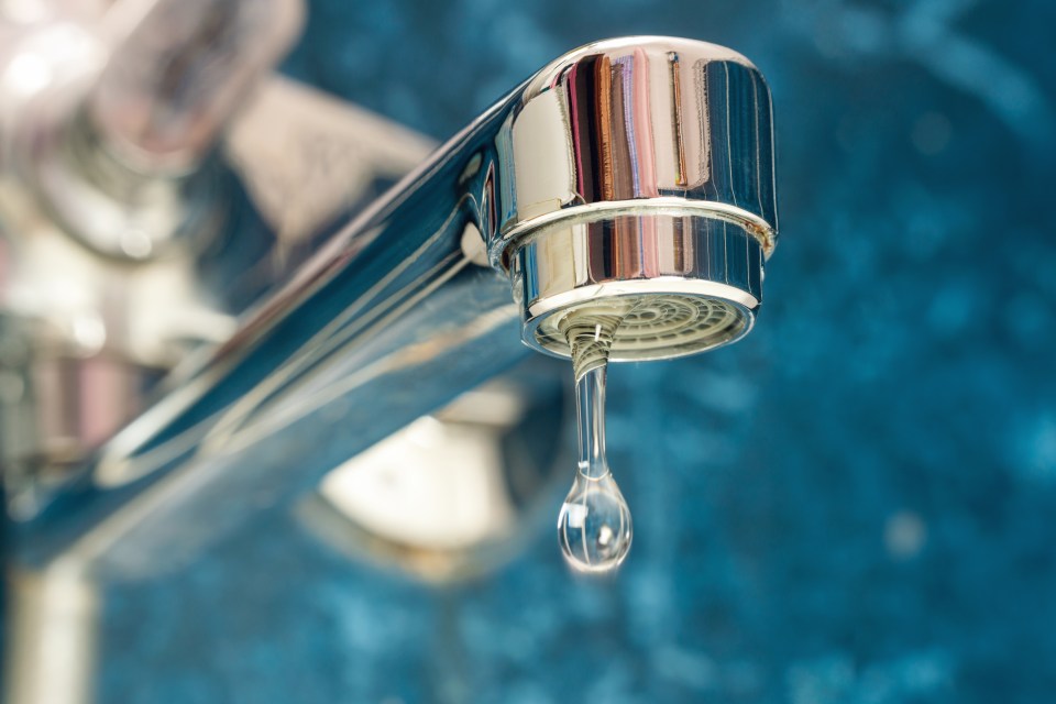 a faucet with a drop of water coming out of it