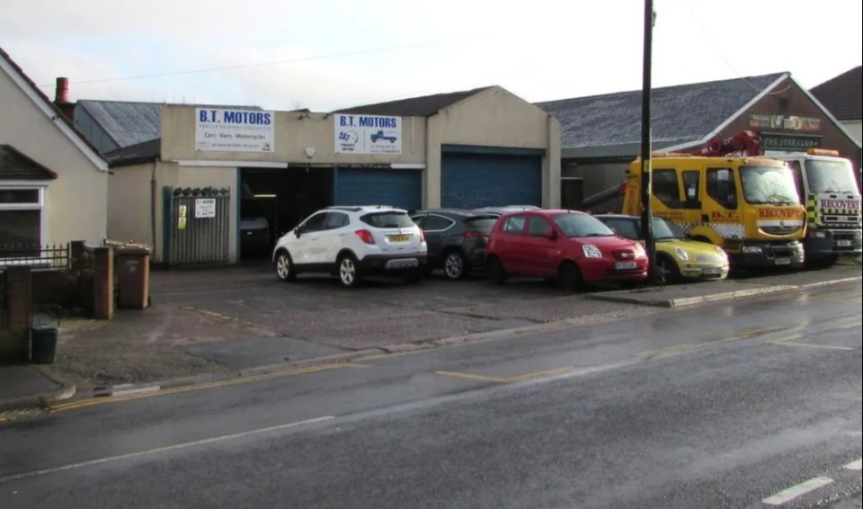 a row of cars are parked in front of a building that says bt motors