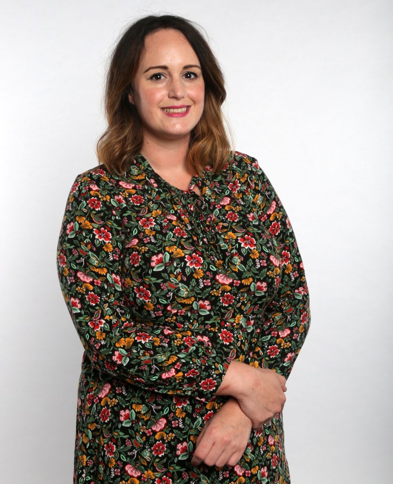 a woman in a floral dress smiles for the camera