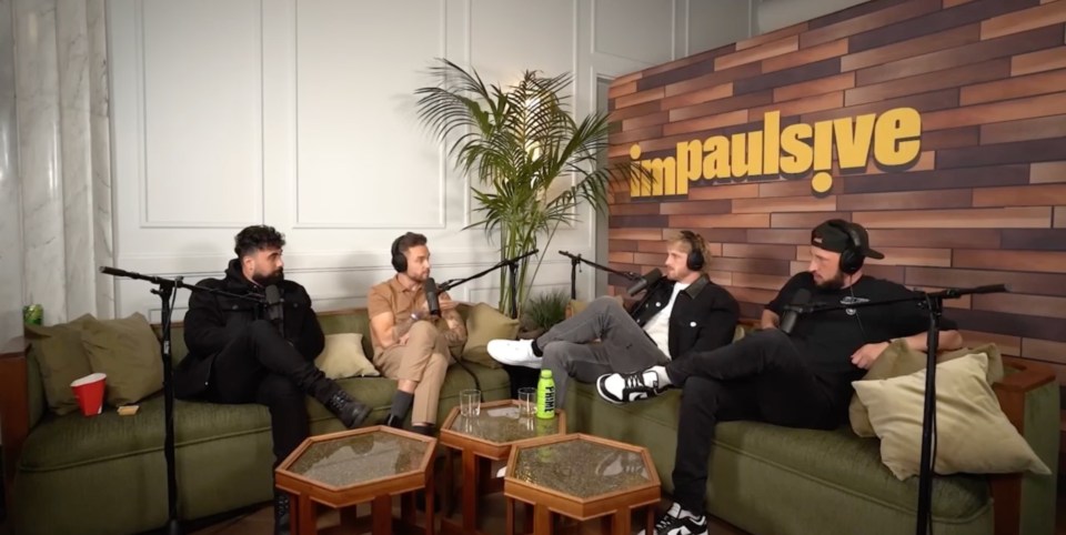 four men sit on a couch in front of a wall that says impulsive