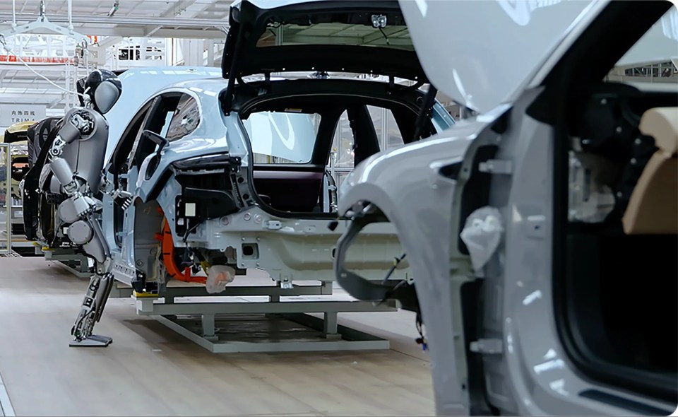 a row of cars are being assembled in a factory