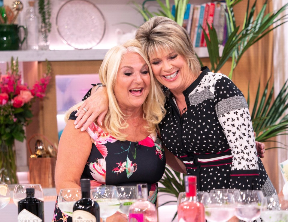 two women are posing for a picture and one of them is wearing a floral dress