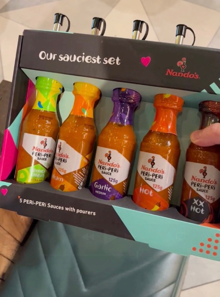 a box of nando 's peri-peri sauces with pourers