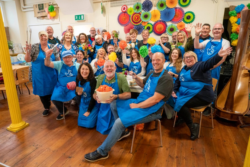 a group of people wearing blue aprons with the word lottery on them