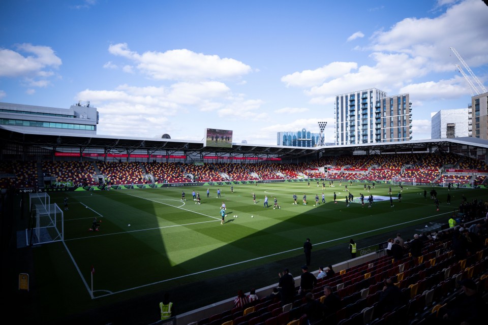 a soccer game is being played in a stadium sponsored by coca cola