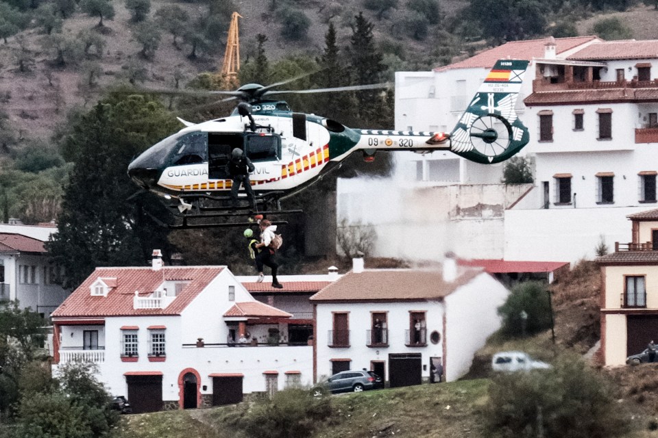 a helicopter from the guardia civil is flying over a residential area