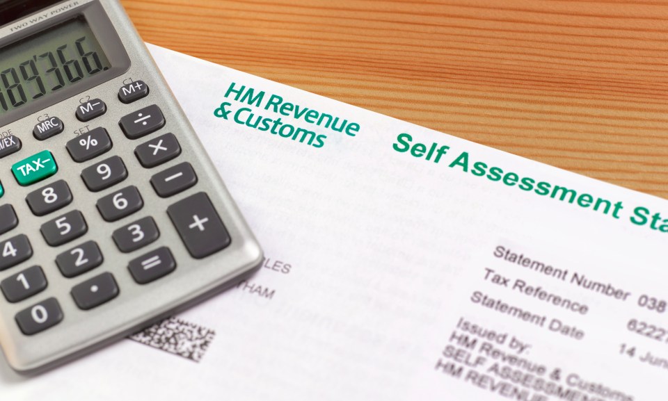 a calculator sits on top of a hm revenue and customs self assessment statement