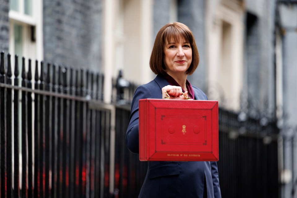 a woman is holding a red briefcase that says treasurer of the exchequer