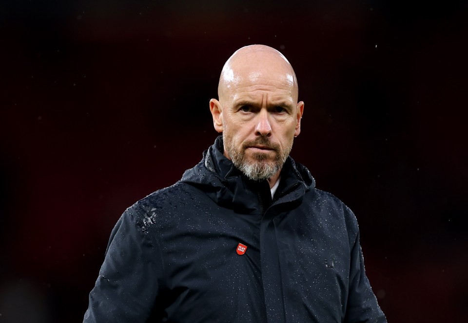 a bald man with a beard wears a black jacket with a red patch that says ' united ' on it