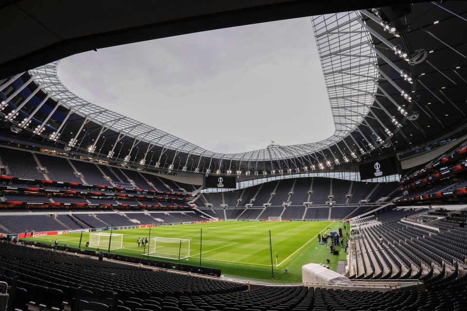 an empty soccer stadium with the word tottenham on the roof