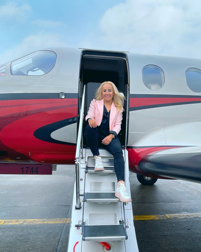 a woman sits on the steps of an airplane with the number 1744 on the side