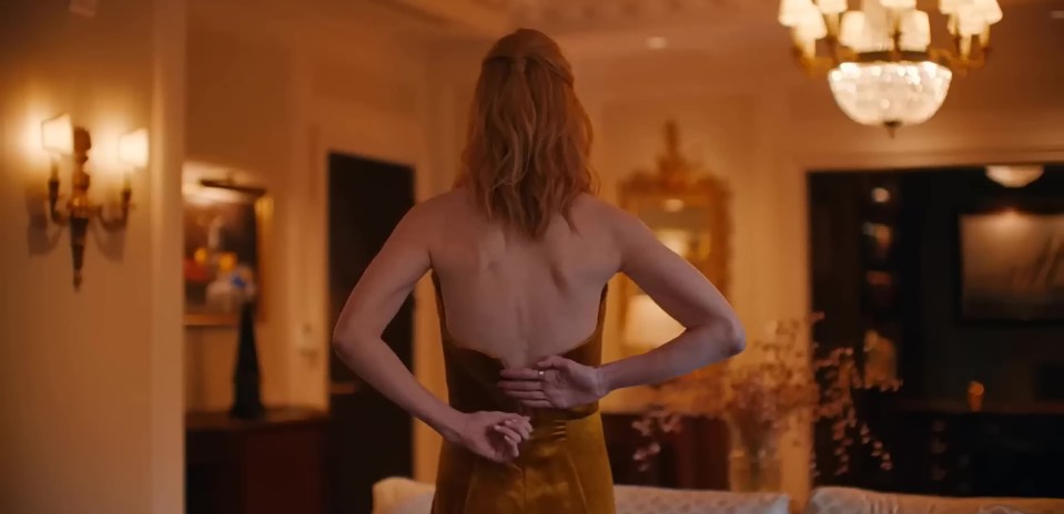 Nicole's character Romy sheds her gold dress in a hotel tryst