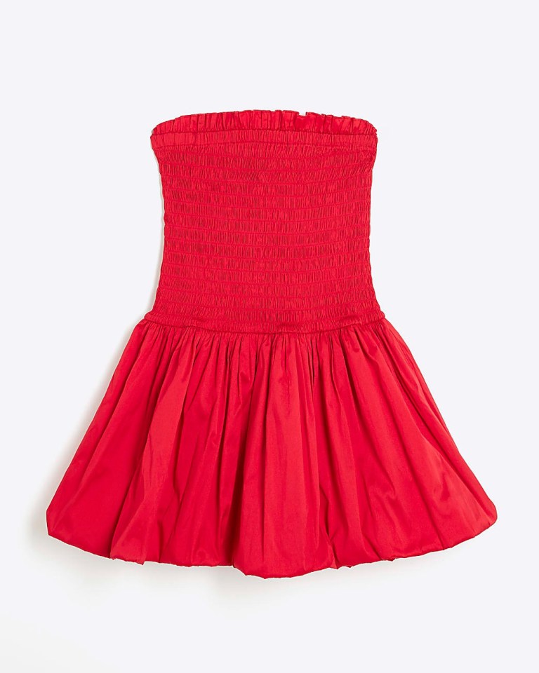 a strapless red dress with a pleated skirt