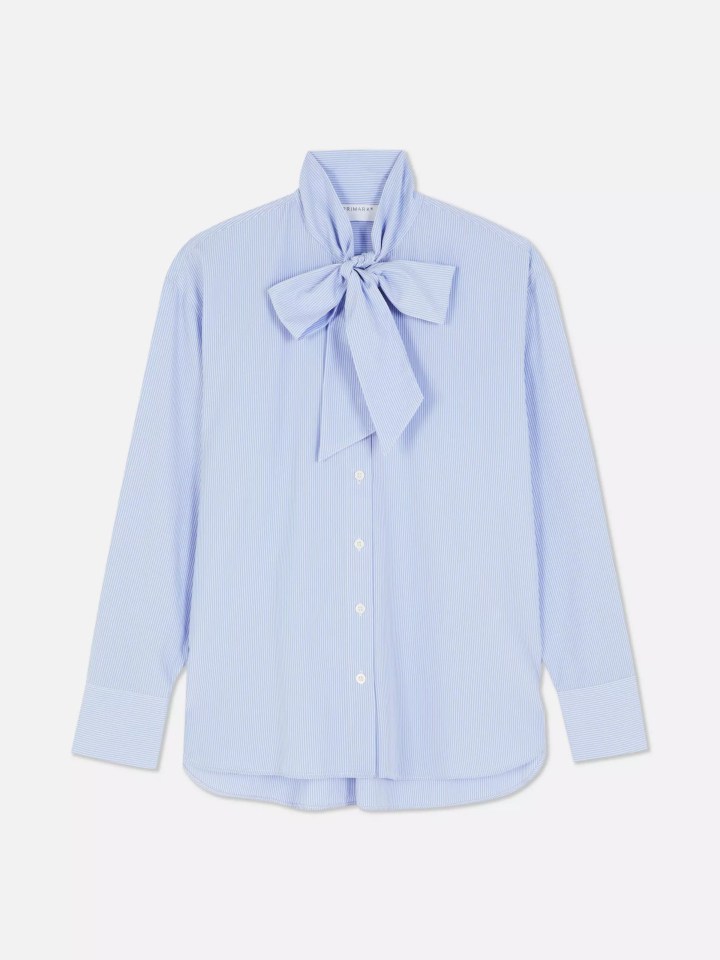 a light blue shirt with a bow around the neck