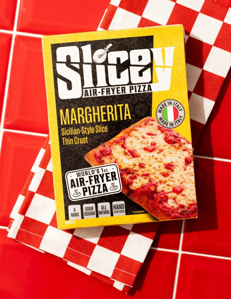 a box of slice air fryer pizza sits on a checkered napkin