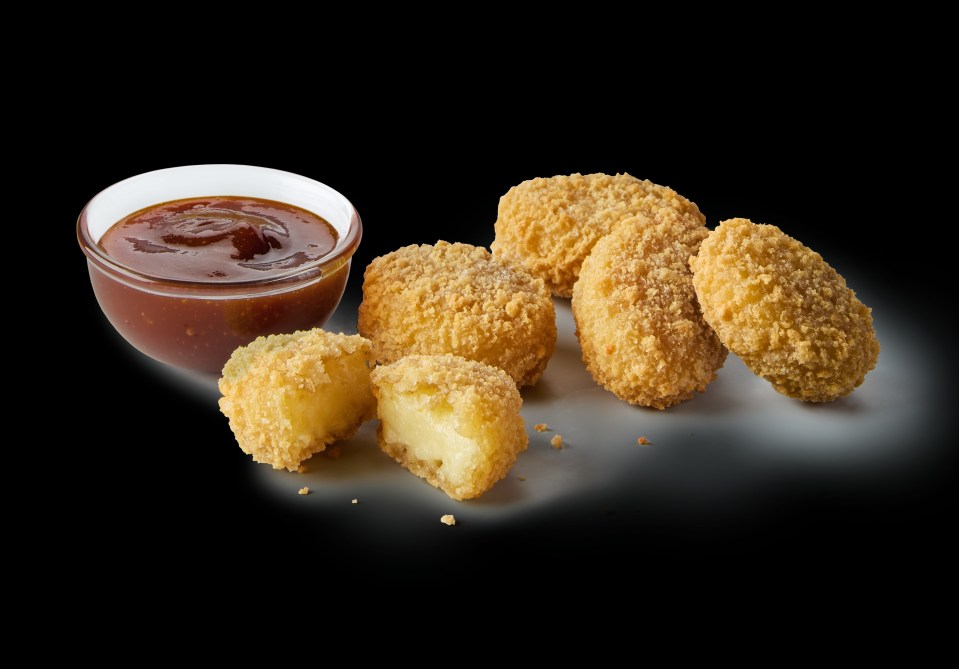 a plate of chicken nuggets with ketchup on a green background