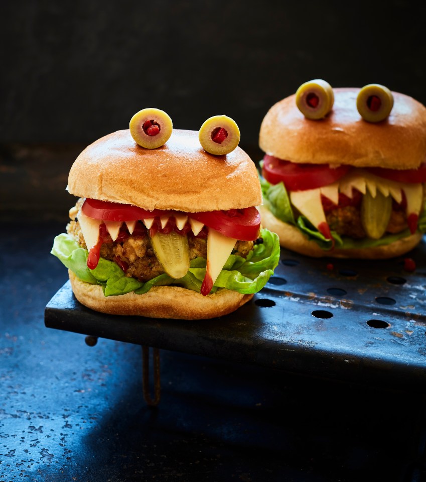 two hamburgers that look like monsters are on a tray