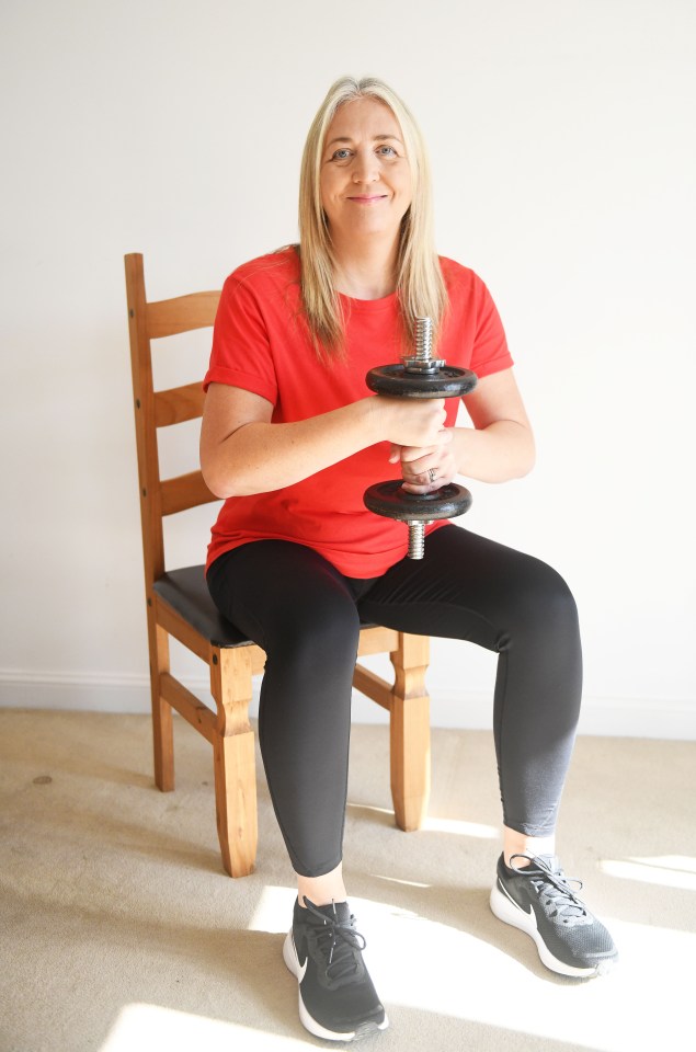 Bending at the hips and the knees but keeping a straight spine, slowly (to the count of four seconds) lower yourself on to the chair