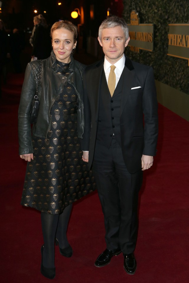 a man and woman are standing on a red carpet in front of a sign that says the gentlemen 's club