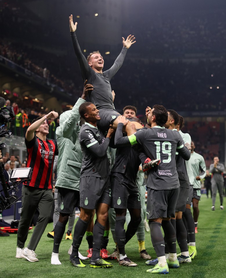 His AC Milan team-mates lifted him up high