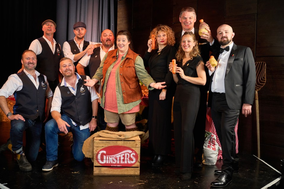 a group of people posing in front of a box that says ginsters