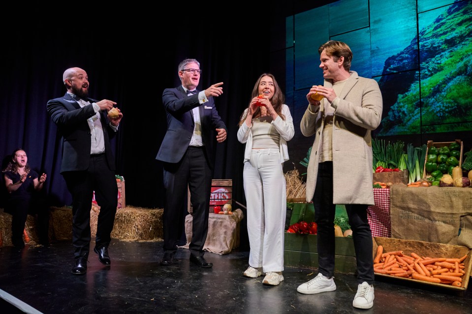 a group of people on a stage with a sign that says juice