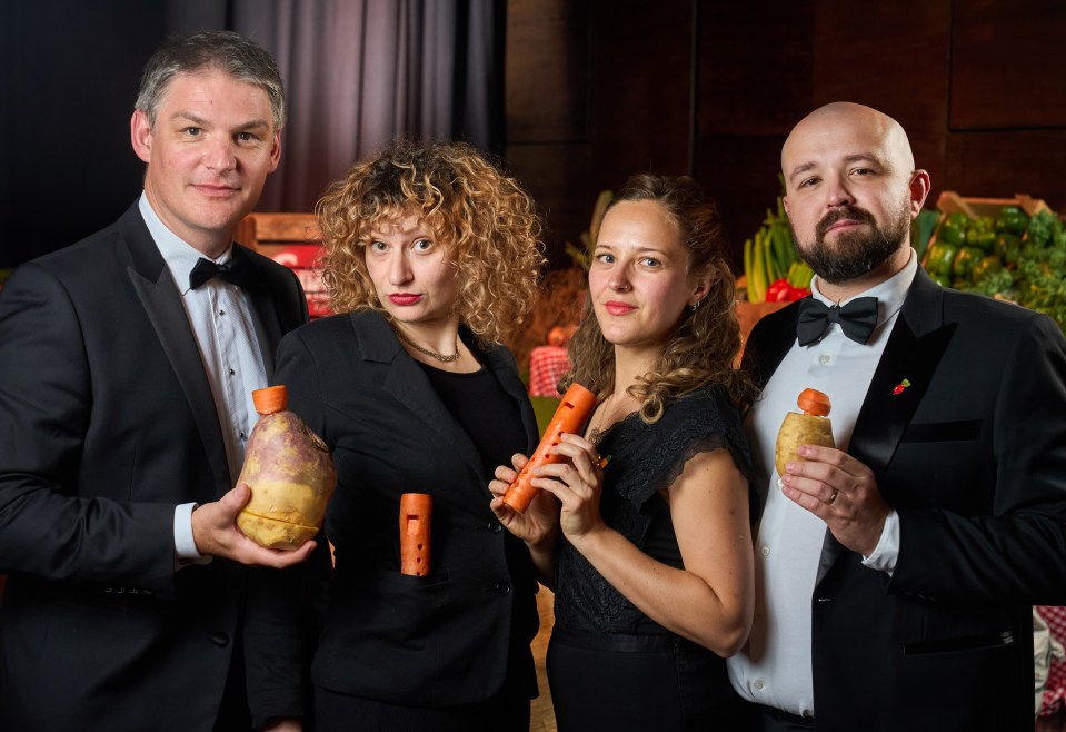 a group of people holding carrots and whistles