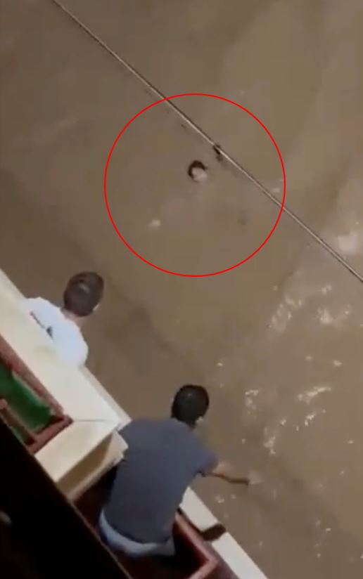 Footage showed one woman desperately holding on for her life while in the flood water