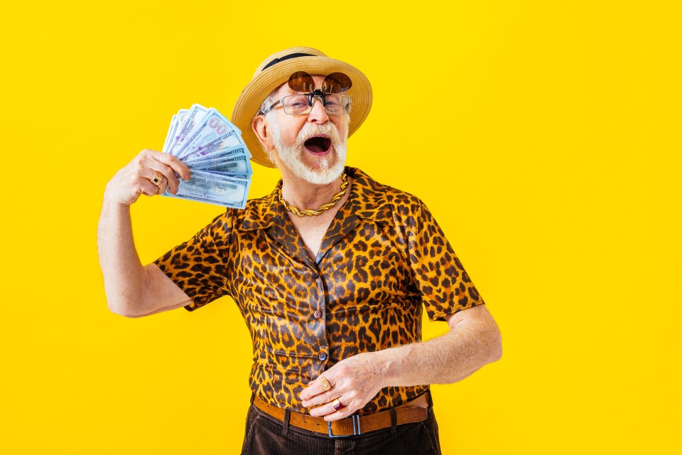 a man in a leopard print shirt is holding a fan of money