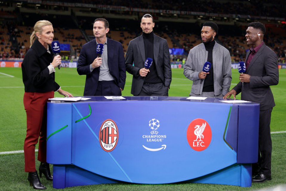 a group of people standing around a table that says champions league