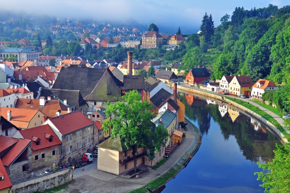 an aerial view of a small town with a river running through it