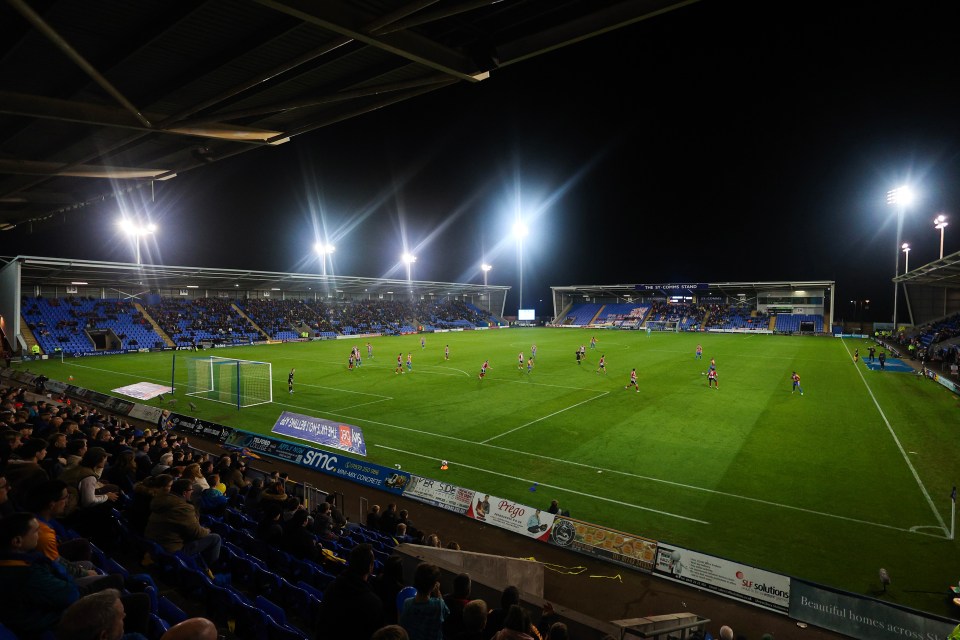 a soccer game is being played in a stadium with advertisements for a variety of companies