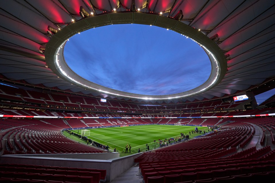 an empty soccer stadium with a large circle in the middle