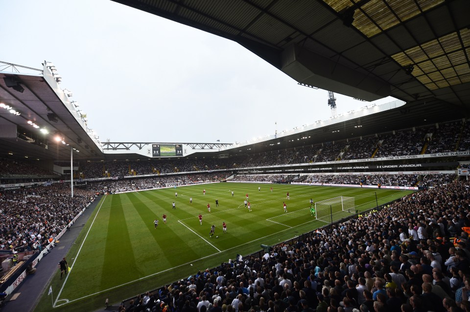 a soccer stadium with a scoreboard that says ' manchester united ' on it