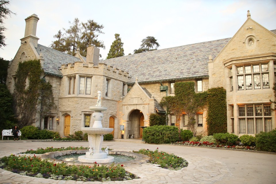 a large stone building with a fountain in front of it