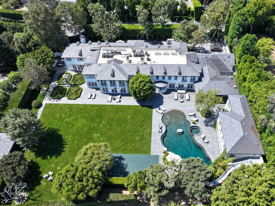 an aerial view of a large house with a large pool