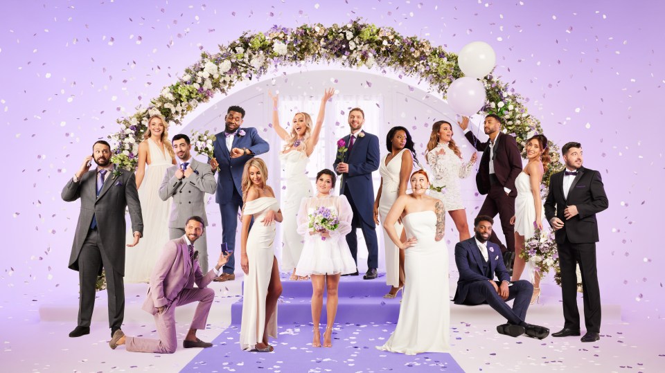 a group of people posing in front of a wedding arch