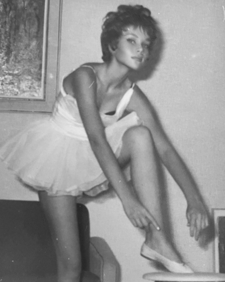 a black and white photo of a woman in a tutu