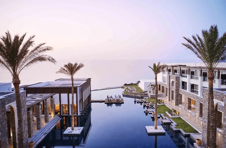 The serene saltwater pool at palatial Grecotel Amirandes Boutique Resort