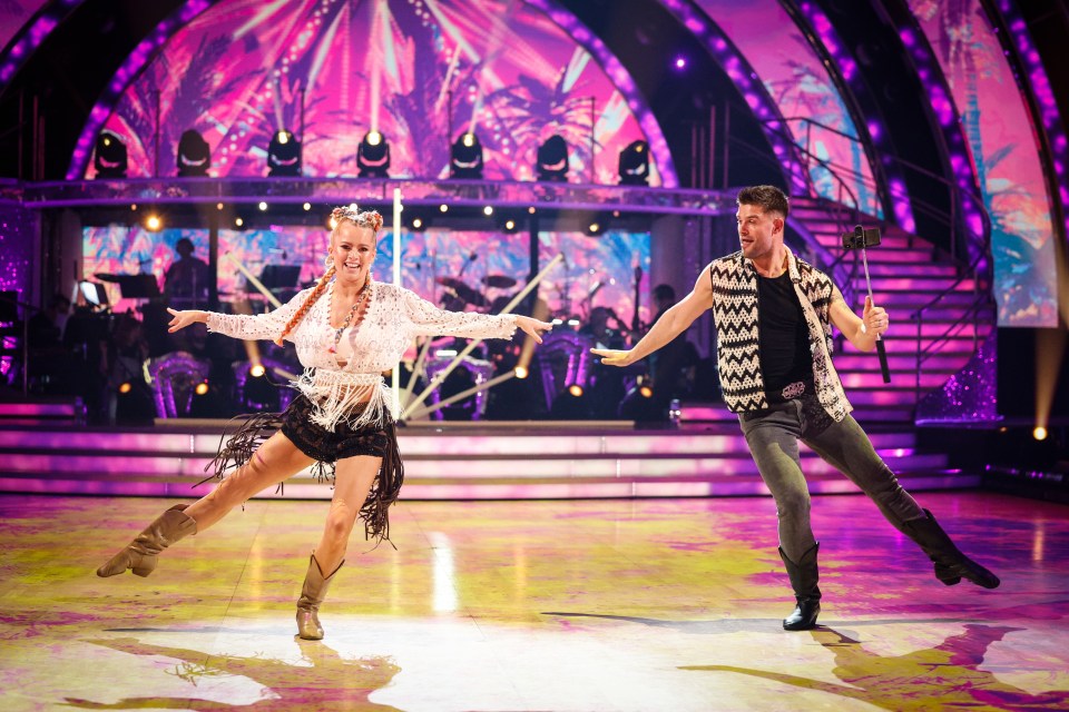 a man and a woman are dancing on a stage