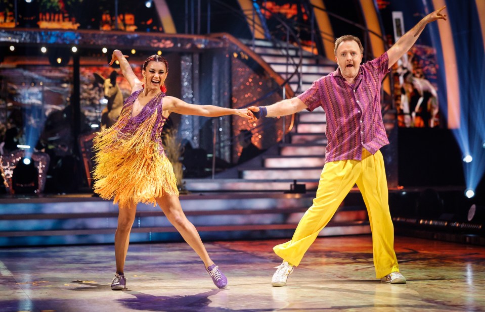 a man and a woman are dancing on a stage