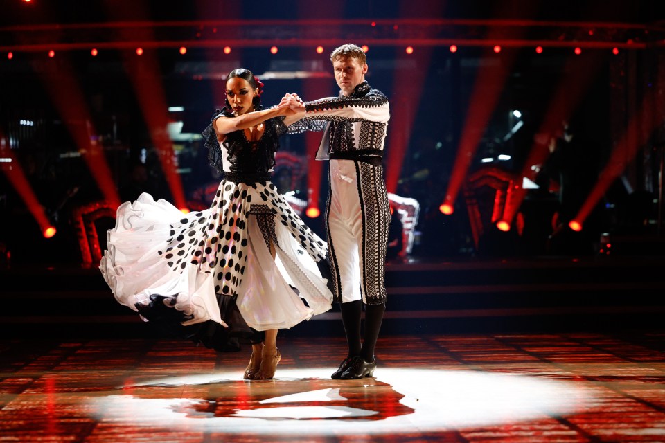 a man and a woman are dancing on a stage