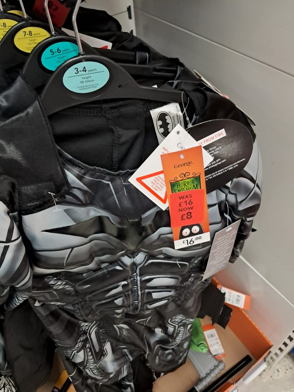 a batman costume with a tag that says george on it