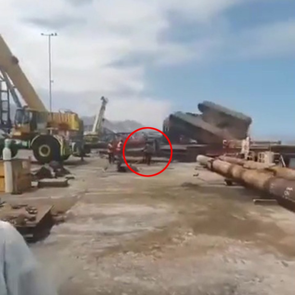 a red circle shows a person standing in the middle of a construction site