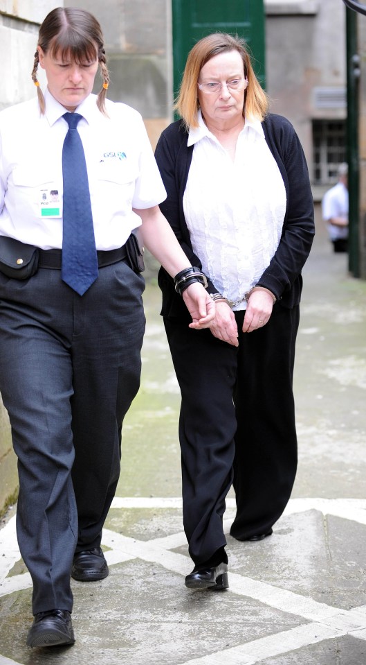 a woman in handcuffs is being escorted by a woman wearing a badge that says ' gdg '