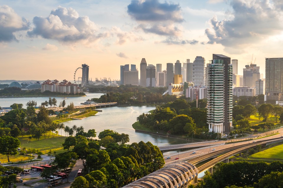 an aerial view of a city with a river in the foreground