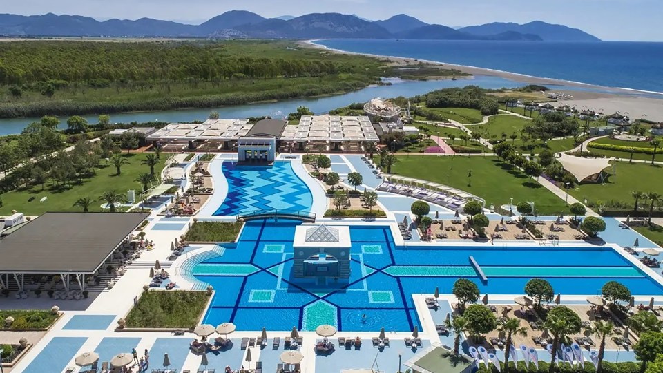 an aerial view of a resort with a large pool