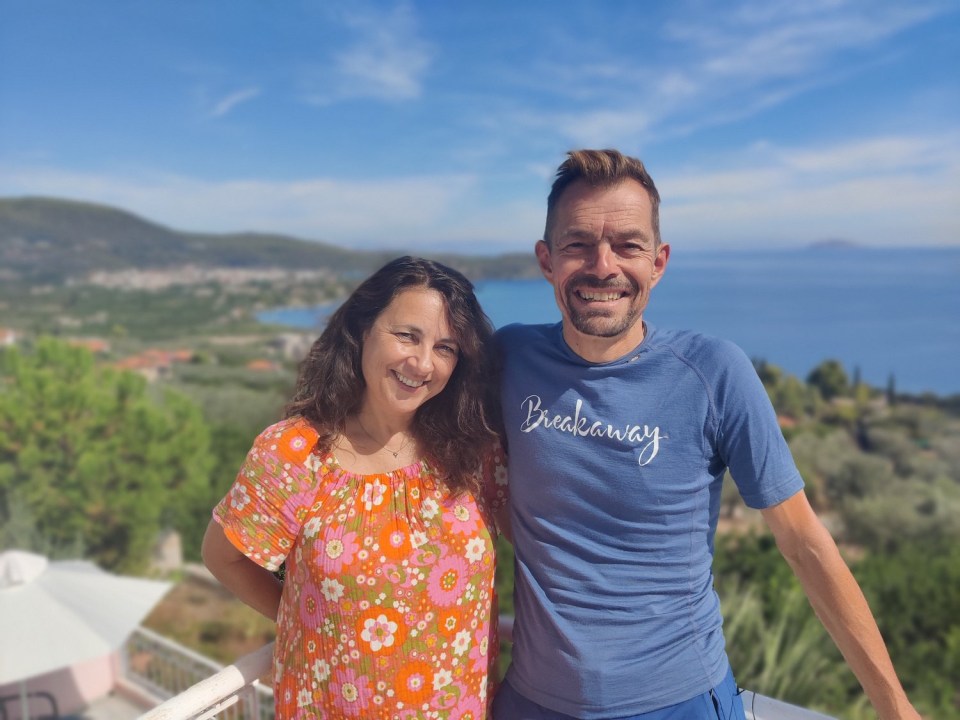 a man wearing a blue breakaway shirt stands next to a woman