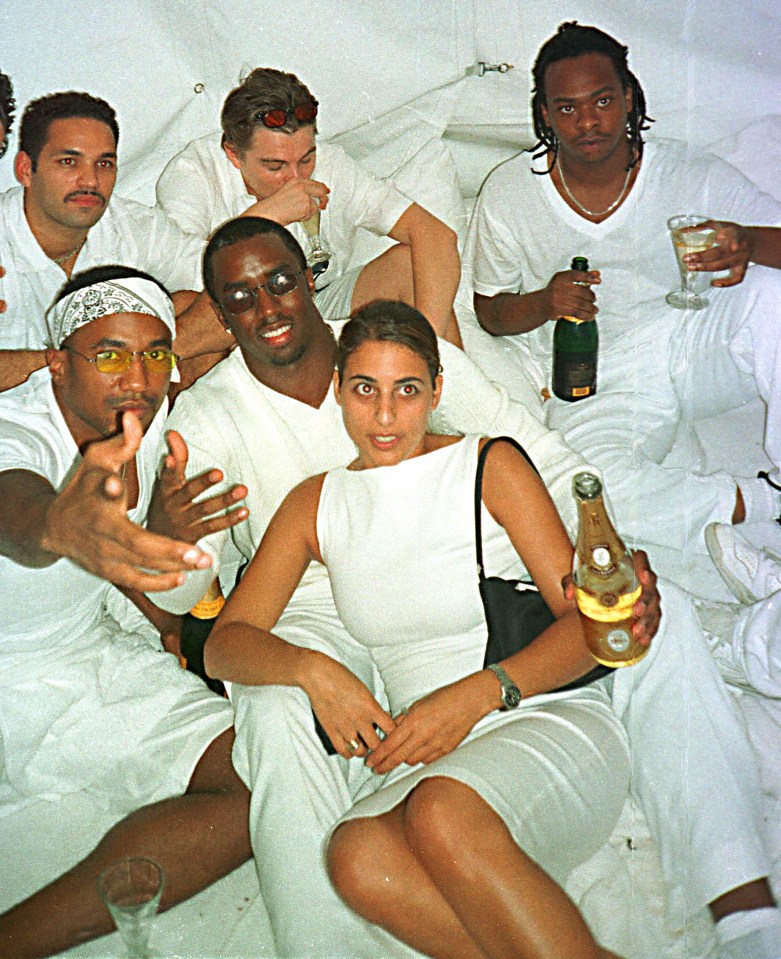 a woman in a white dress is holding a bottle of champagne