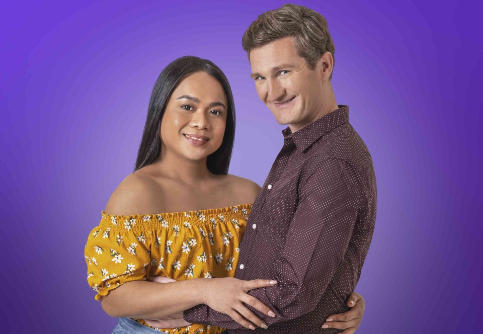 a man and a woman are posing for a picture with a purple background